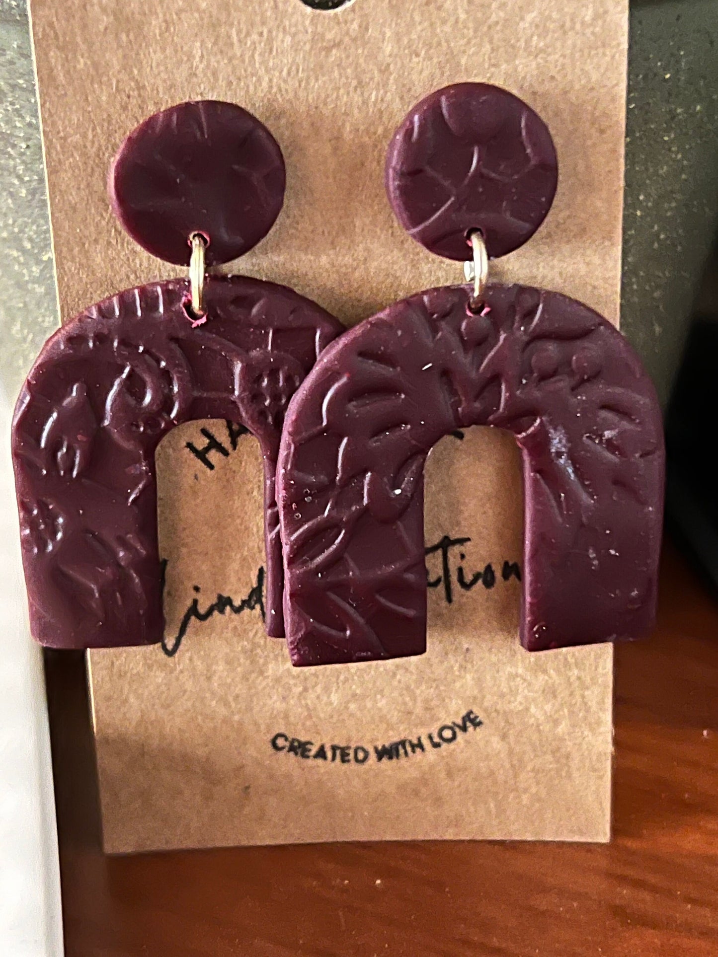 Burgundy lightweight dangling clay earrings in arch shape handmade lightweight textured dark red maroon The Archie