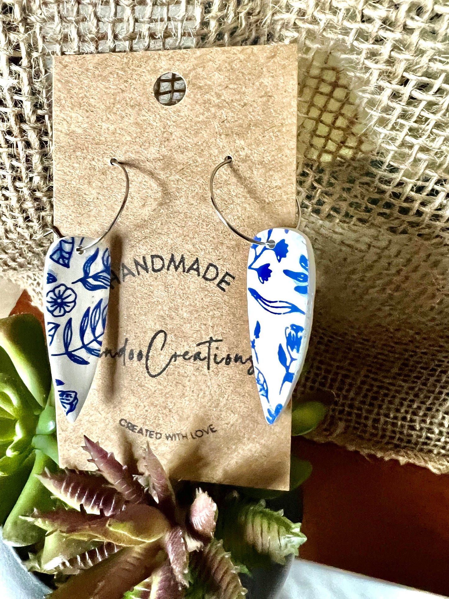Blue & white floral dangling painted clay earrings handmade wire hoop closure lightweight The Dagger