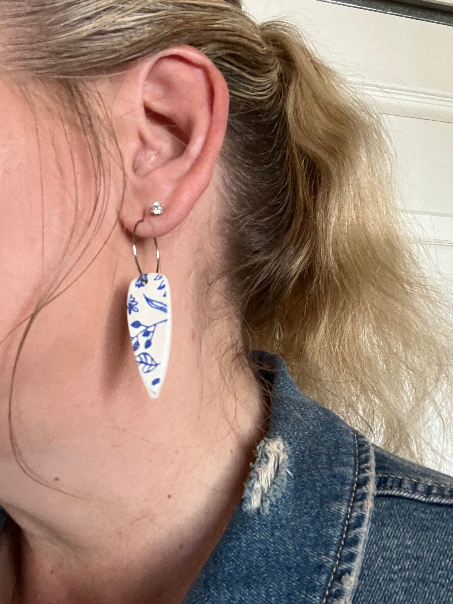 Blue & white floral dangling painted clay earrings handmade wire hoop closure lightweight The Dagger